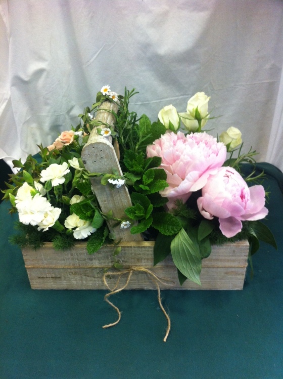Rustic table arrangement made for colleage featuring peonies, spray roses & herbs